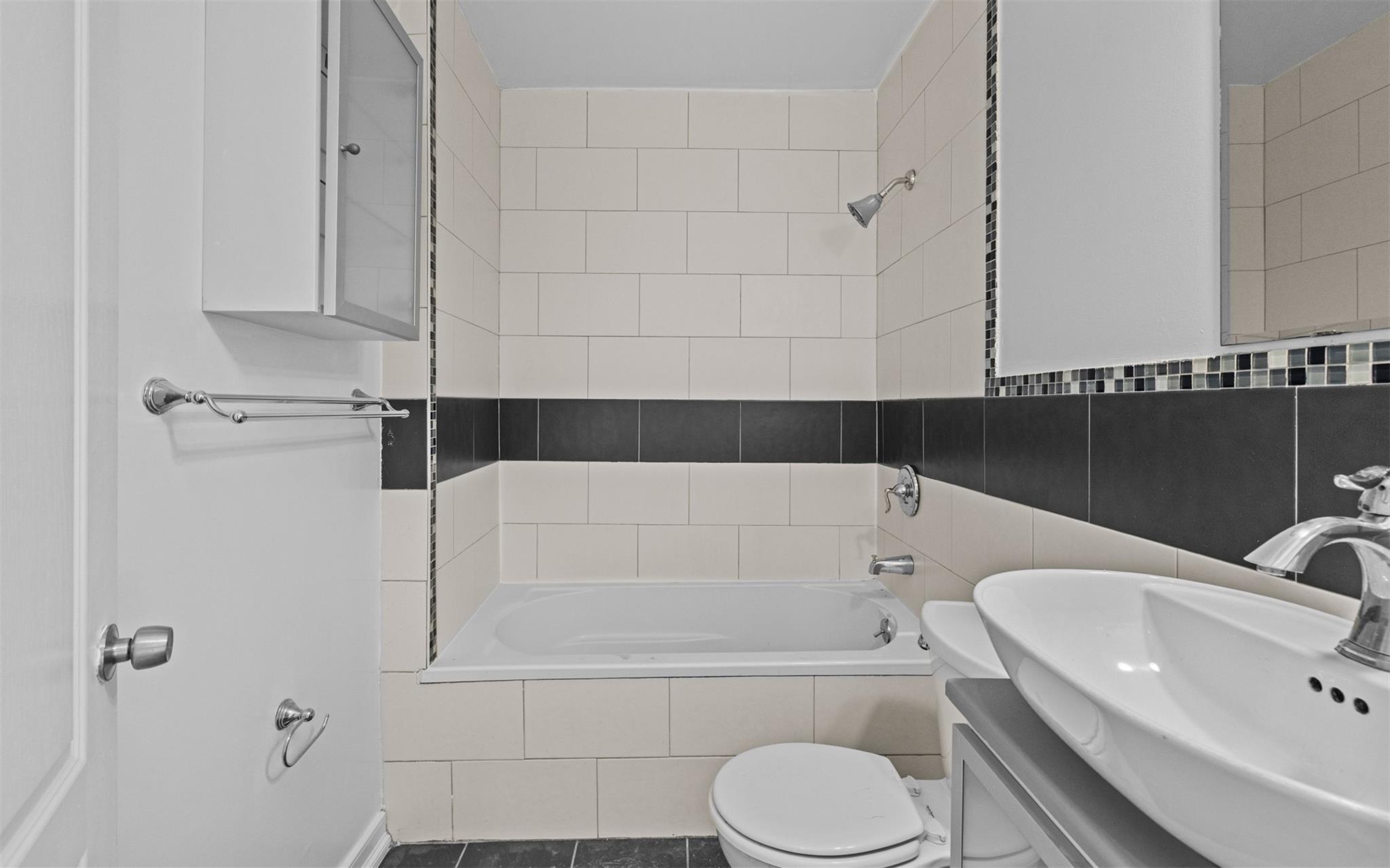 626 Madison Street Brooklyn, NY 11221 - Photo 8 of 42 Bathroom with toilet, tiled shower / bath combo, and vanity