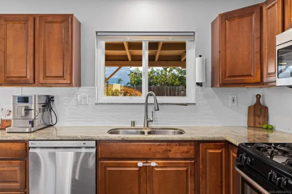 a kitchen with stainless steel appliances granite countertop a sink stove and cabinets