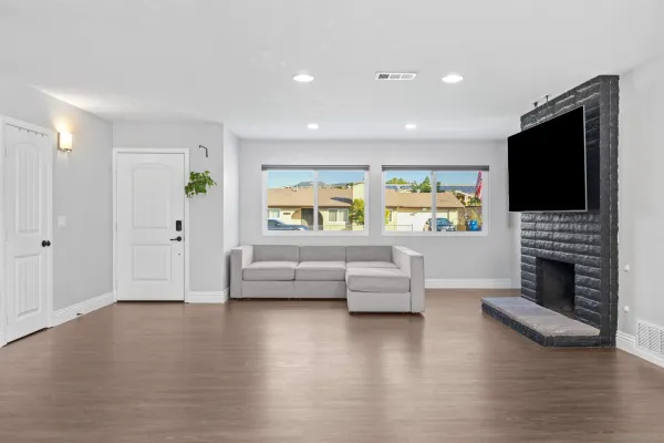 a living room with furniture a fireplace and a flat screen tv