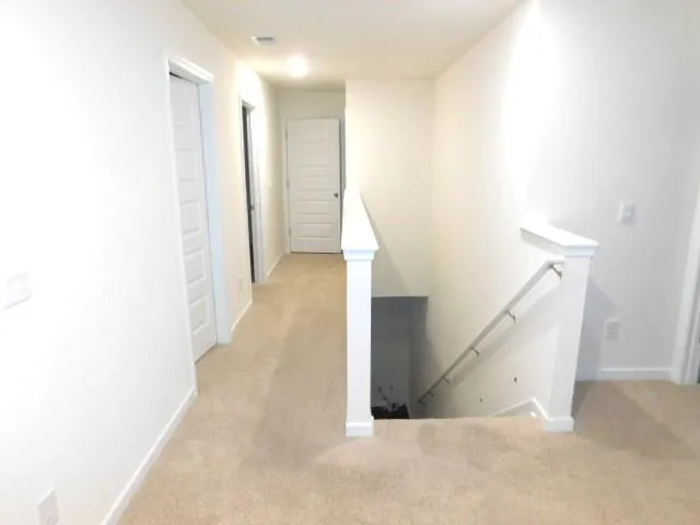 a view of a hallway with staircase