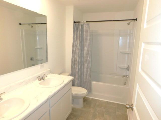 3689 Chevington Court Southeast Atlanta, GA 30354 - Photo 24 of 30 a bathroom with a granite countertop sink toilet and shower