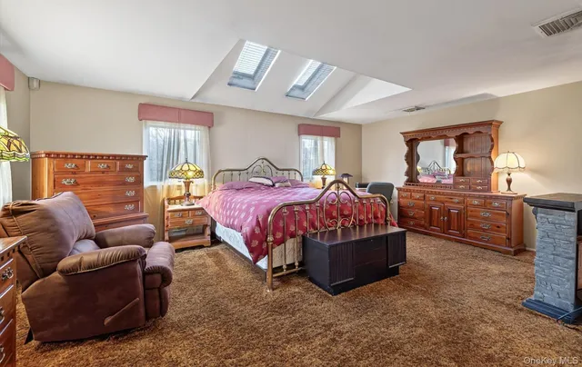 a bedroom with a bed window and couch