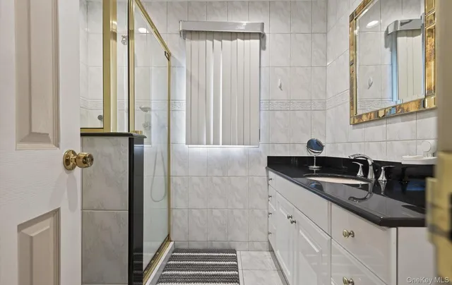 a bathroom with double sink and a mirror
