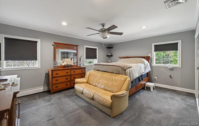 a spacious bedroom with a bed and a flat screen tv