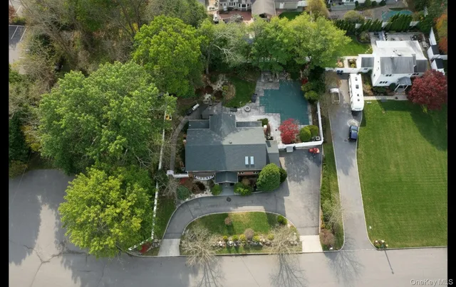 an aerial view of a house with outdoor space pool seating area and yard
