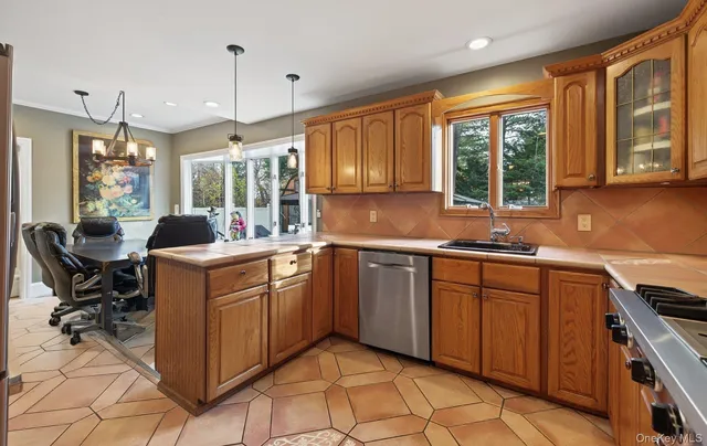 a kitchen with granite countertop a sink stove and cabinets