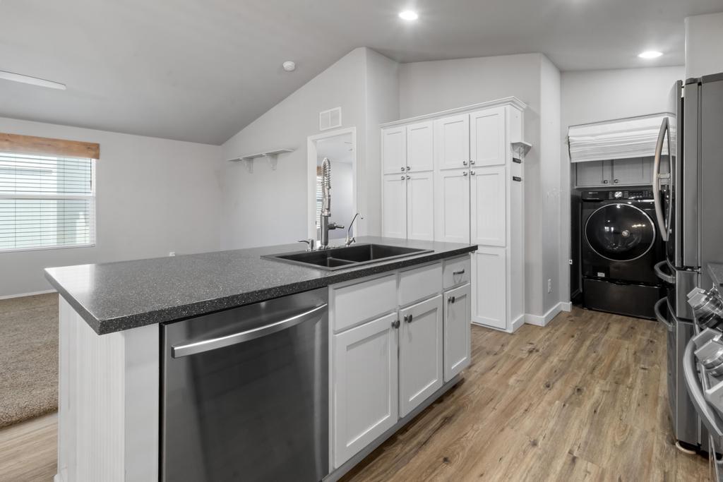 1545 East El Rodeo Road, Unit 42 Fort Mohave, AZ 86426 - Photo 22 of 45 a kitchen with a sink stove and cabinets