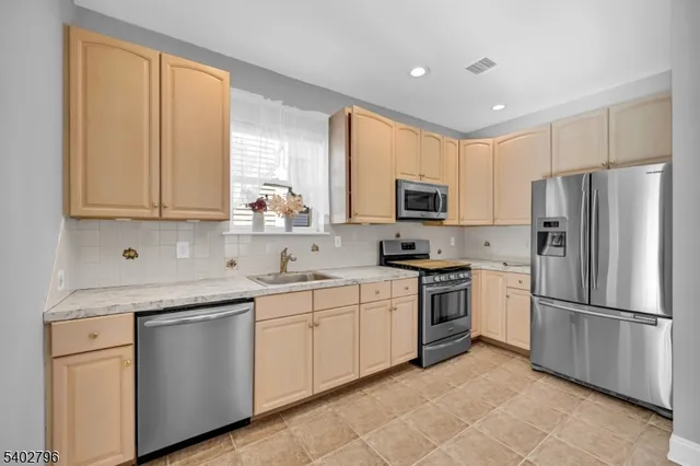 a kitchen with a sink stove and refrigerator