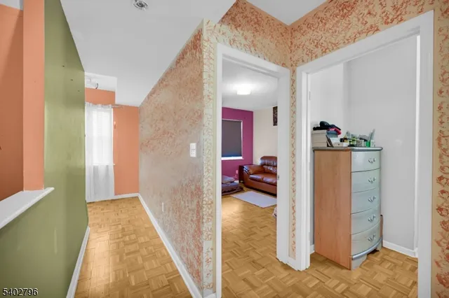 a view of a hallway with livingroom and furniture