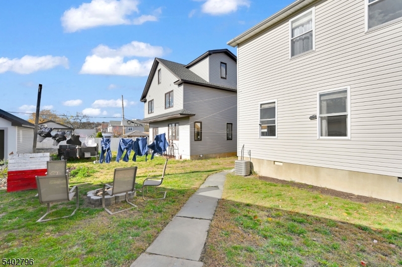 48 Main Avenue Wallington, NJ 07057 - Photo 45 of 50 a swimming pool with outdoor seating and yard