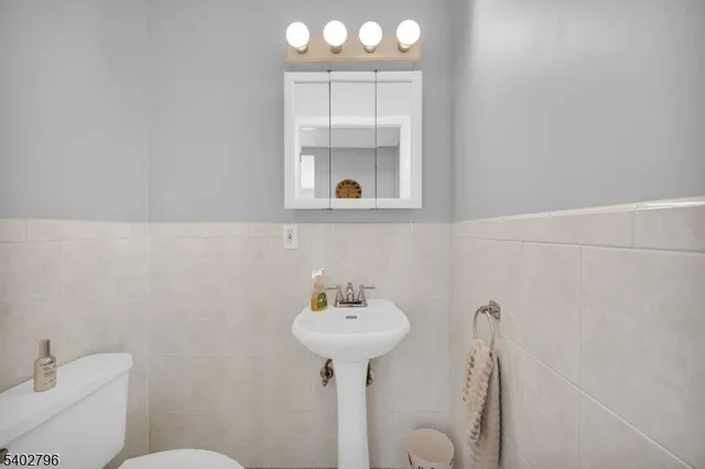 a bathroom with a sink a mirror and a toilet