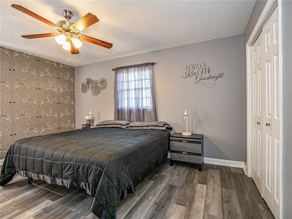 438 Columbus Street Sebastian, FL 32958 - Photo 12 of 32 a bedroom with a bed and a chandelier