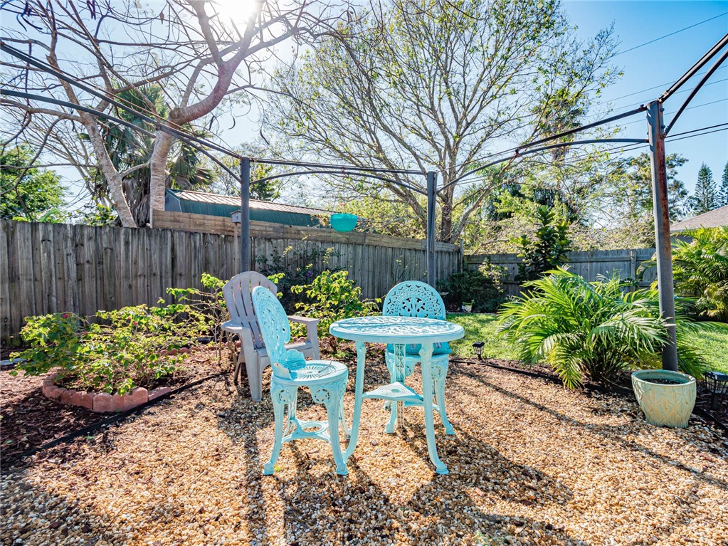 438 Columbus Street Sebastian, FL 32958 - Photo 17 of 32 a view of a table and chairs in back yard of the house