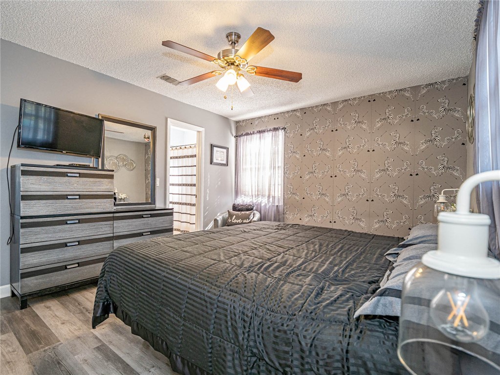 438 Columbus Street Sebastian, FL 32958 - Photo 26 of 32 a bedroom with a bed and a television
