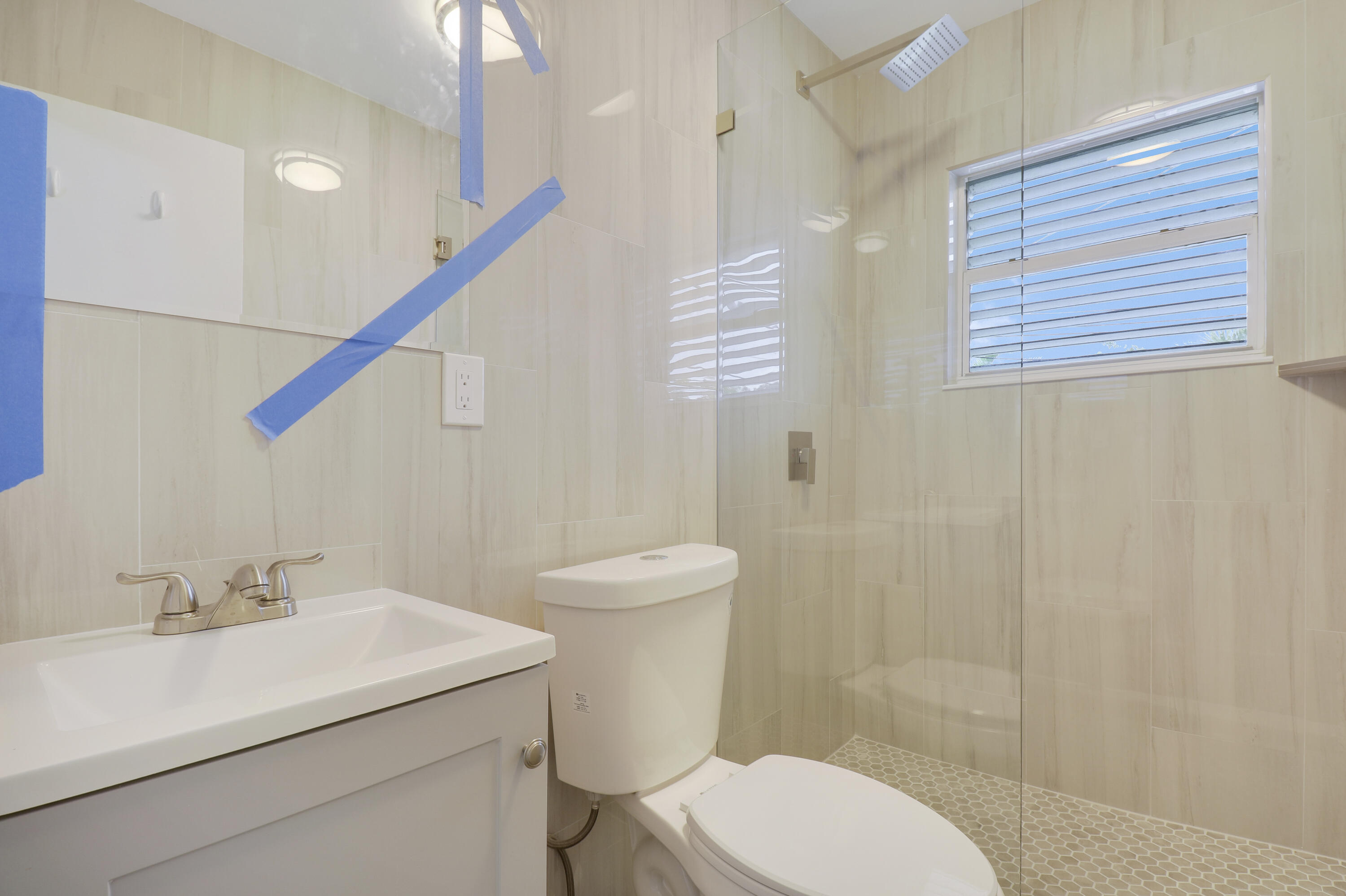 1118 North J Street, Unit C Lake Worth Beach, FL 33460 - Photo 13 of 13 a bathroom with a sink a toilet and shower