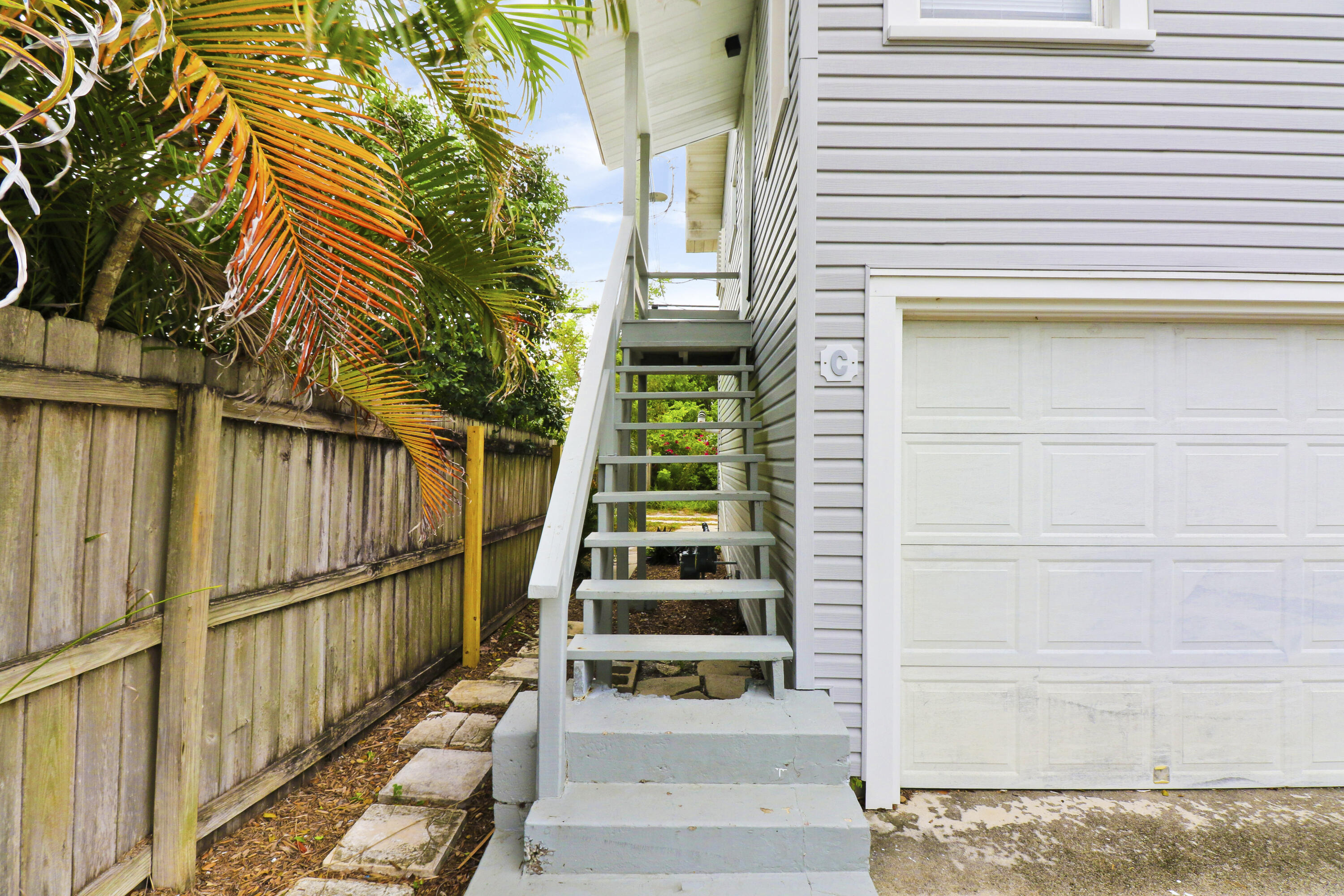 1118 North J Street, Unit C Lake Worth Beach, FL 33460 - Photo 3 of 13 a front view of a house with a yard