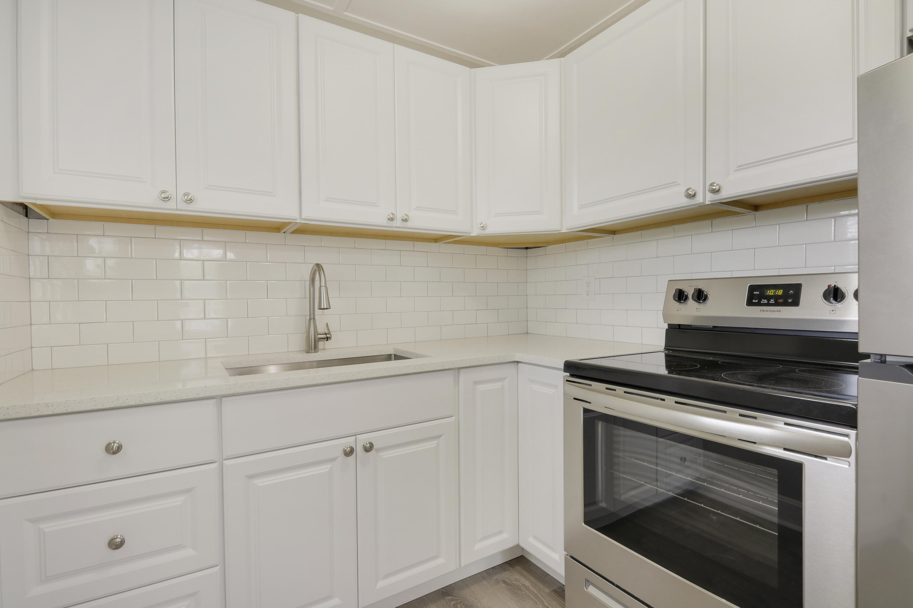 1118 North J Street, Unit C Lake Worth Beach, FL 33460 - Photo 9 of 13 a kitchen with white cabinets and appliances