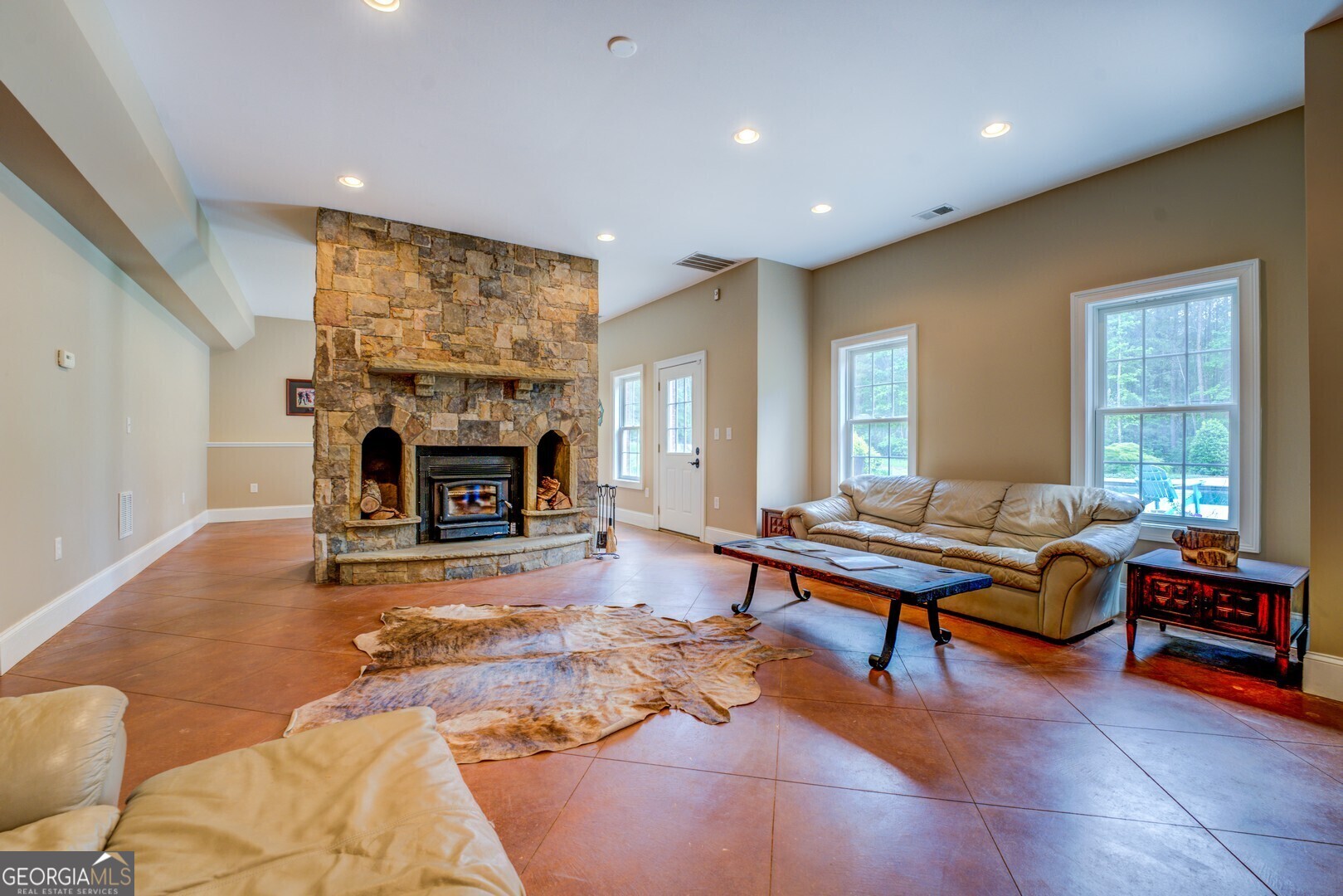 20207 State Highway 11 Monticello, GA 31064 - Photo 110 of 159 a living room with furniture a fireplace and a table