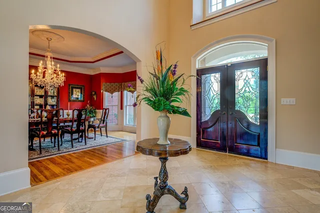 a spacious bathroom with a tub sink and mirror