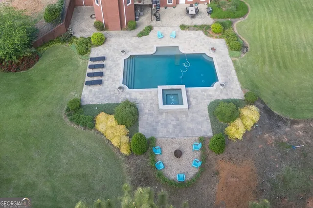 a view of a livingroom with furniture and floor to ceiling window