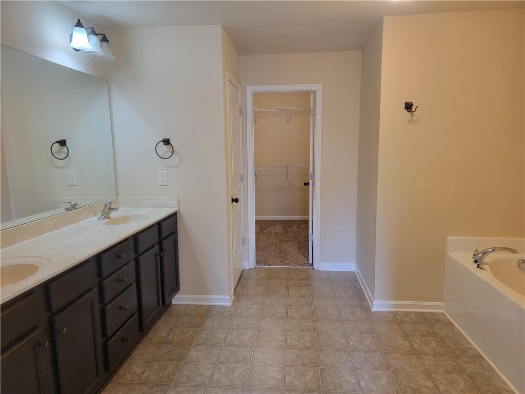2707 Morgan Glen Road Northeast Buford, GA 30519 - Photo 15 of 24 a spacious bathroom with a bathtub sink and mirror