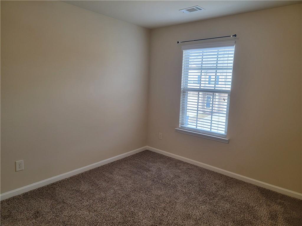 2707 Morgan Glen Road Northeast Buford, GA 30519 - Photo 22 of 24 an empty room with a window