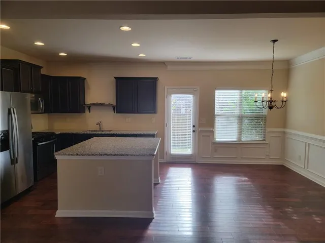 a utility room with wooden floor washer and dryer