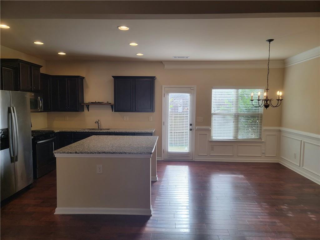 2707 Morgan Glen Road Northeast Buford, GA 30519 - Photo 5 of 24 a utility room with wooden floor washer and dryer
