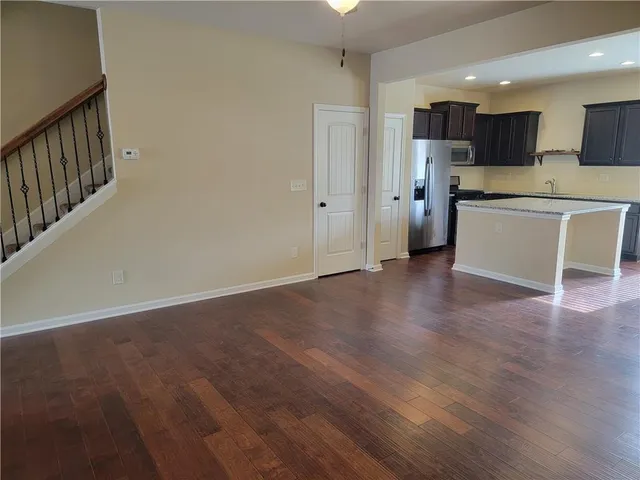 a view of kitchen with wooden floor and electronic appliances