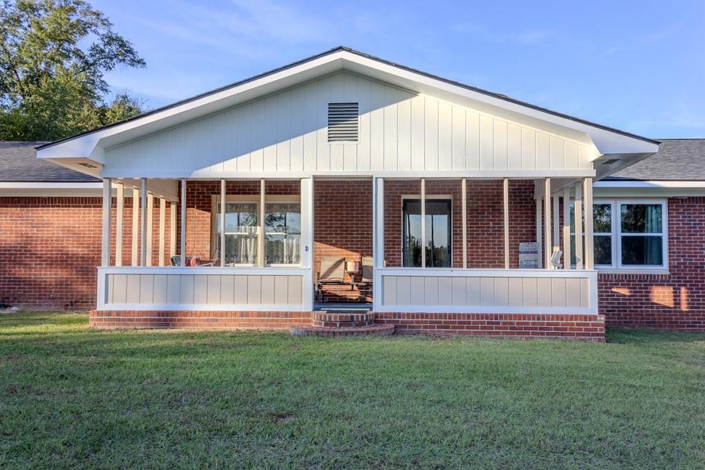a view of a house with backyard and sitting area