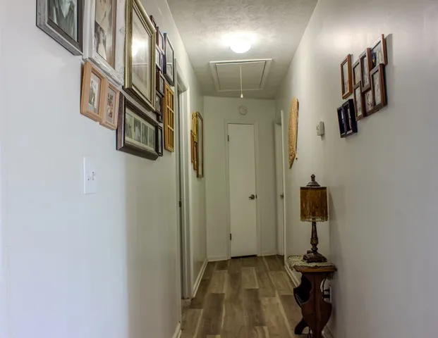 a view of a hallway with paintings on the wall