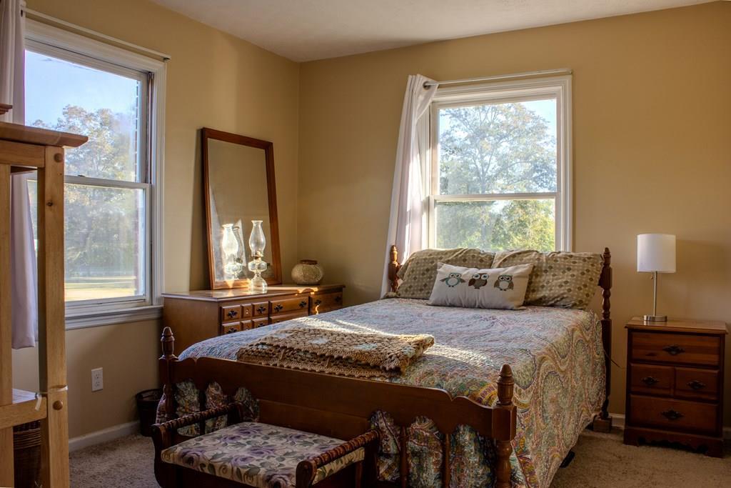 196 Russell Williams Road Eufaula, AL 36027 - Photo 19 of 30 a bedroom with a bed a closet and windows