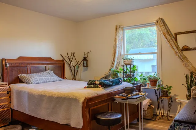 a bedroom with a bed and a table