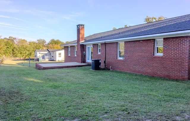 a front view of a house with a garden and yard