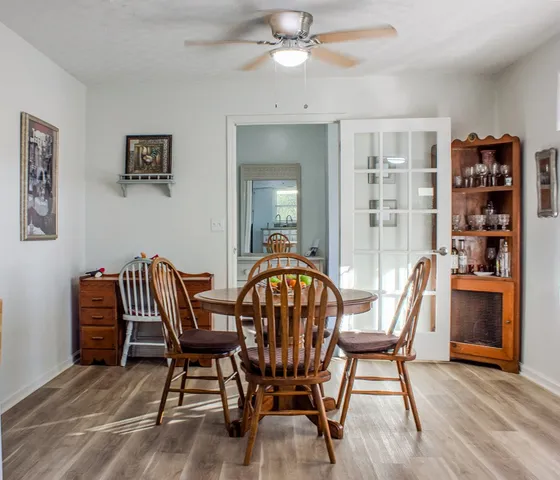 a view of a dining room with furniture and wooden floor