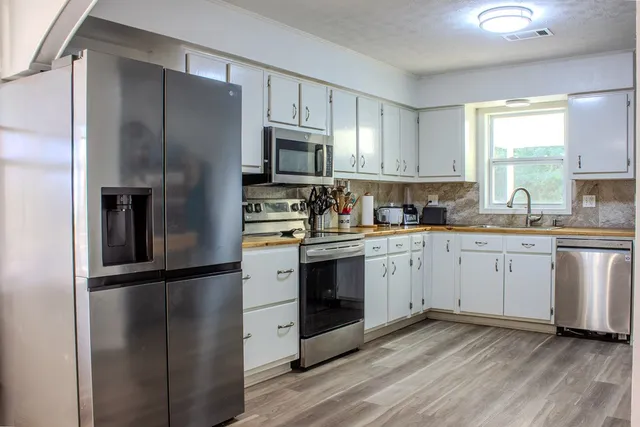 a kitchen with a refrigerator stove and microwave