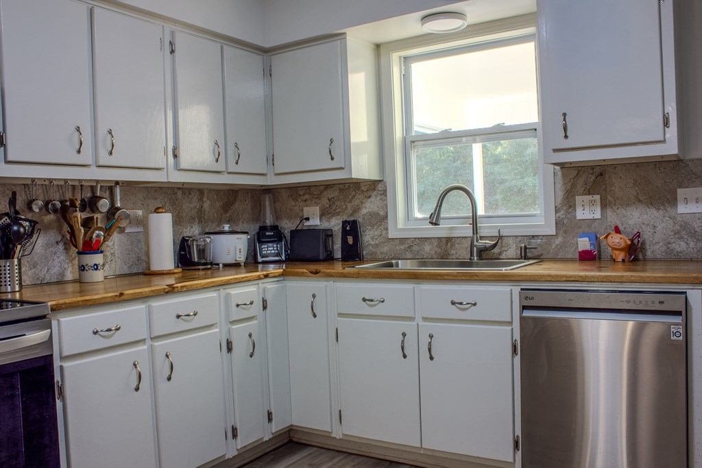 196 Russell Williams Road Eufaula, AL 36027 - Photo 9 of 30 a kitchen with white cabinets and sink