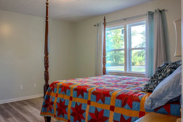 a bedroom with a bed and a window