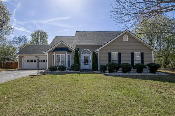 a front view of house with yard and green space