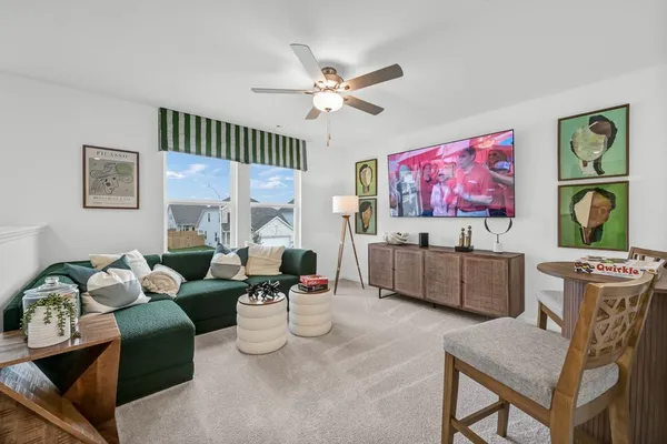 a living room with furniture and large windows