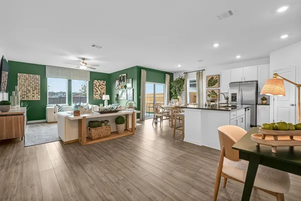 a living room with furniture and view of kitchen