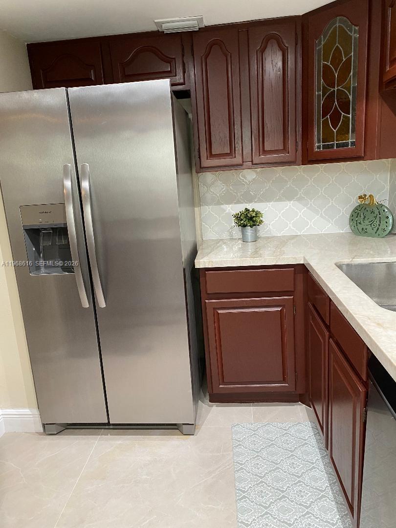 11339 Southwest 71st Lane Miami, FL 33173 - Photo 11 of 19 a kitchen with granite countertop a refrigerator and a sink