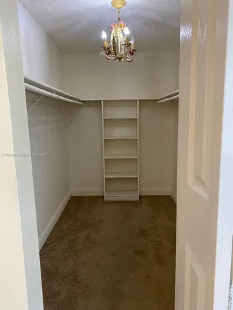 a view of an empty room with a chandelier