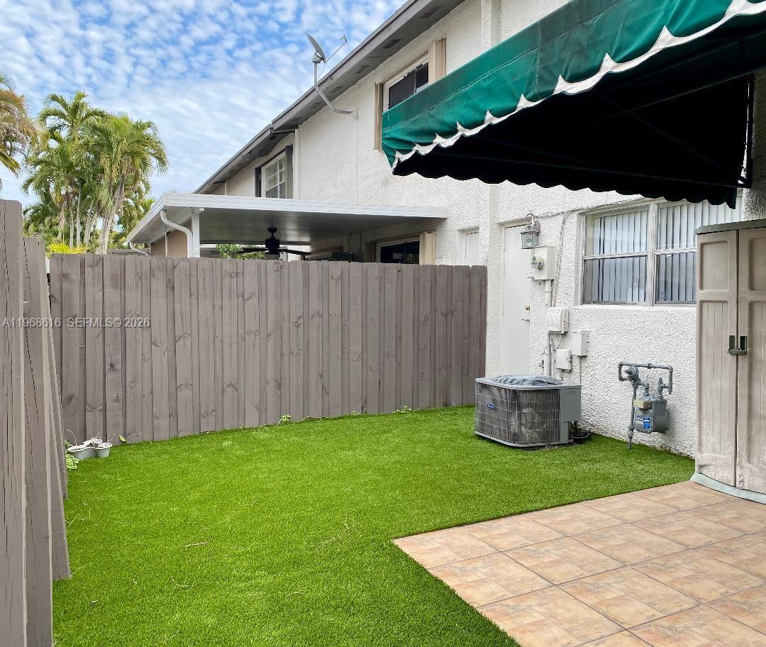11339 Southwest 71st Lane Miami, FL 33173 - Photo 19 of 19 a backyard of a house with table and chairs