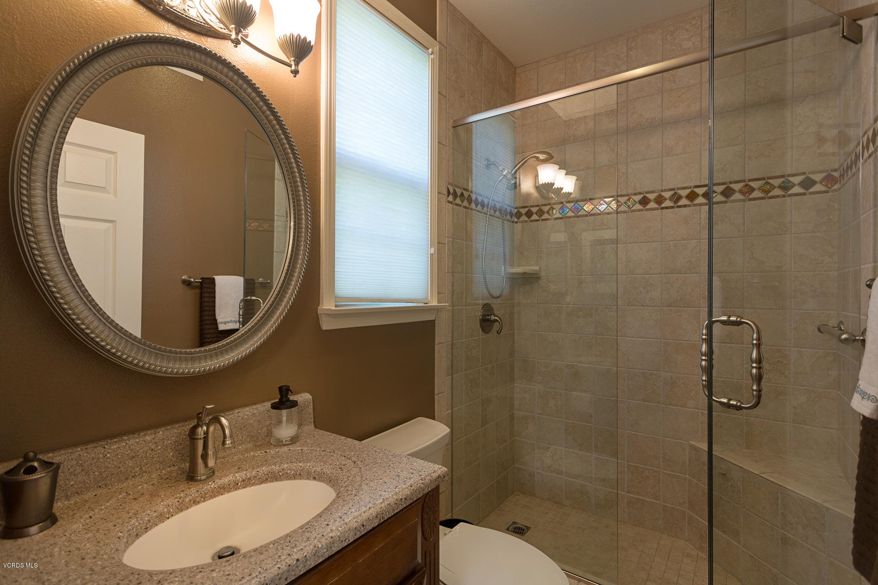 558 Rustic Hills Drive Simi Valley, CA 93065 - Photo 23 of 50 a bathroom with a granite countertop sink a mirror and shower