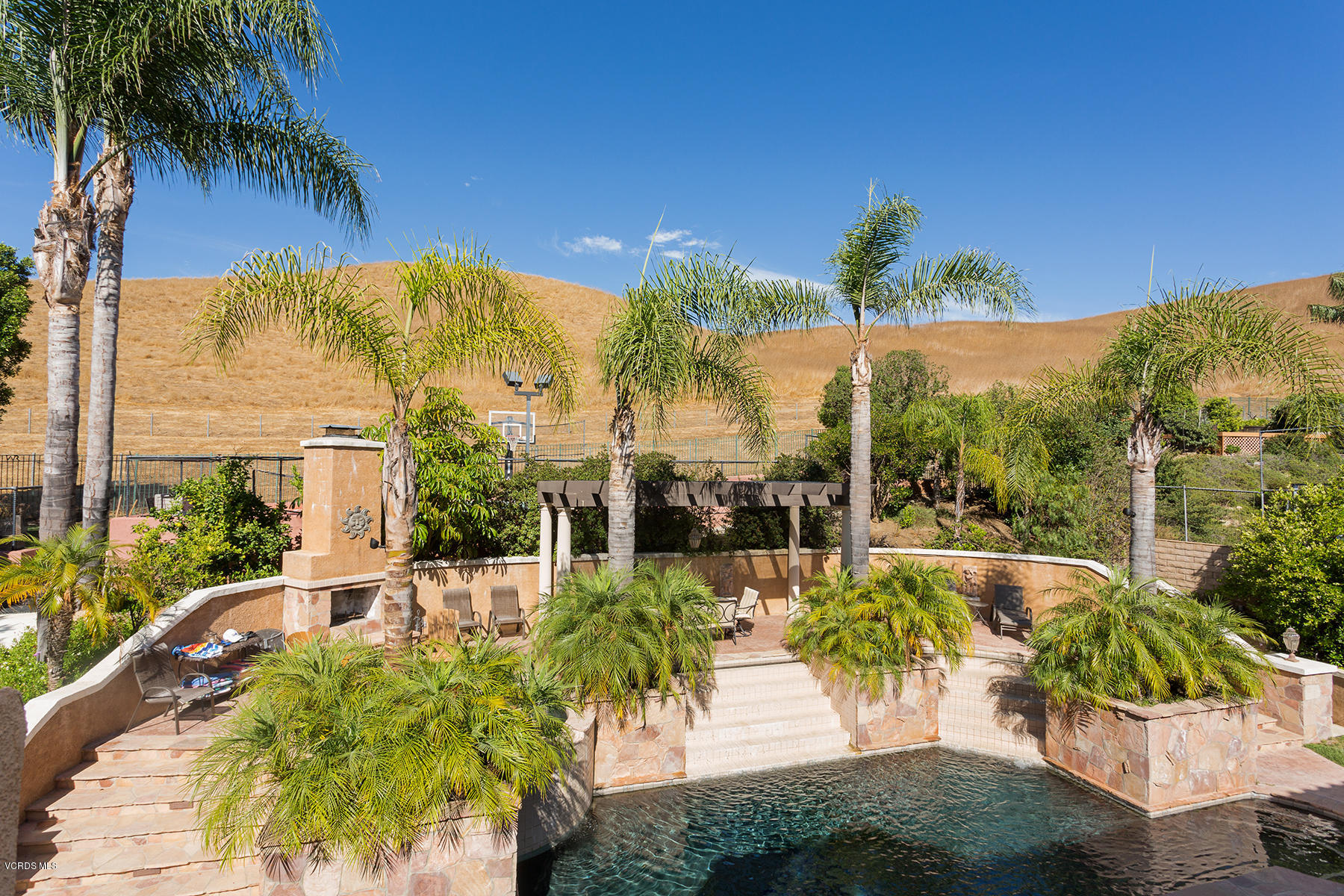 558 Rustic Hills Drive Simi Valley, CA 93065 - Photo 28 of 50 a view of a swimming pool with a patio