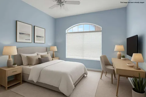 a bedroom with a bed and a chandelier