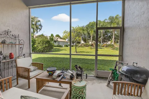 a view of a patio with couches plants and garden
