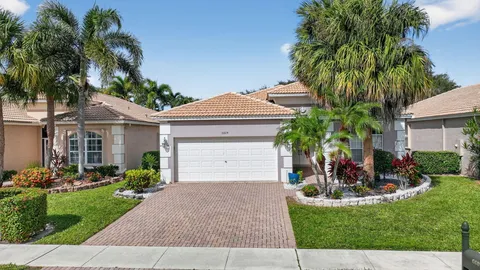 a front view of a house with a yard and potted plants