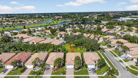 an aerial view of residential houses with outdoor space and trees